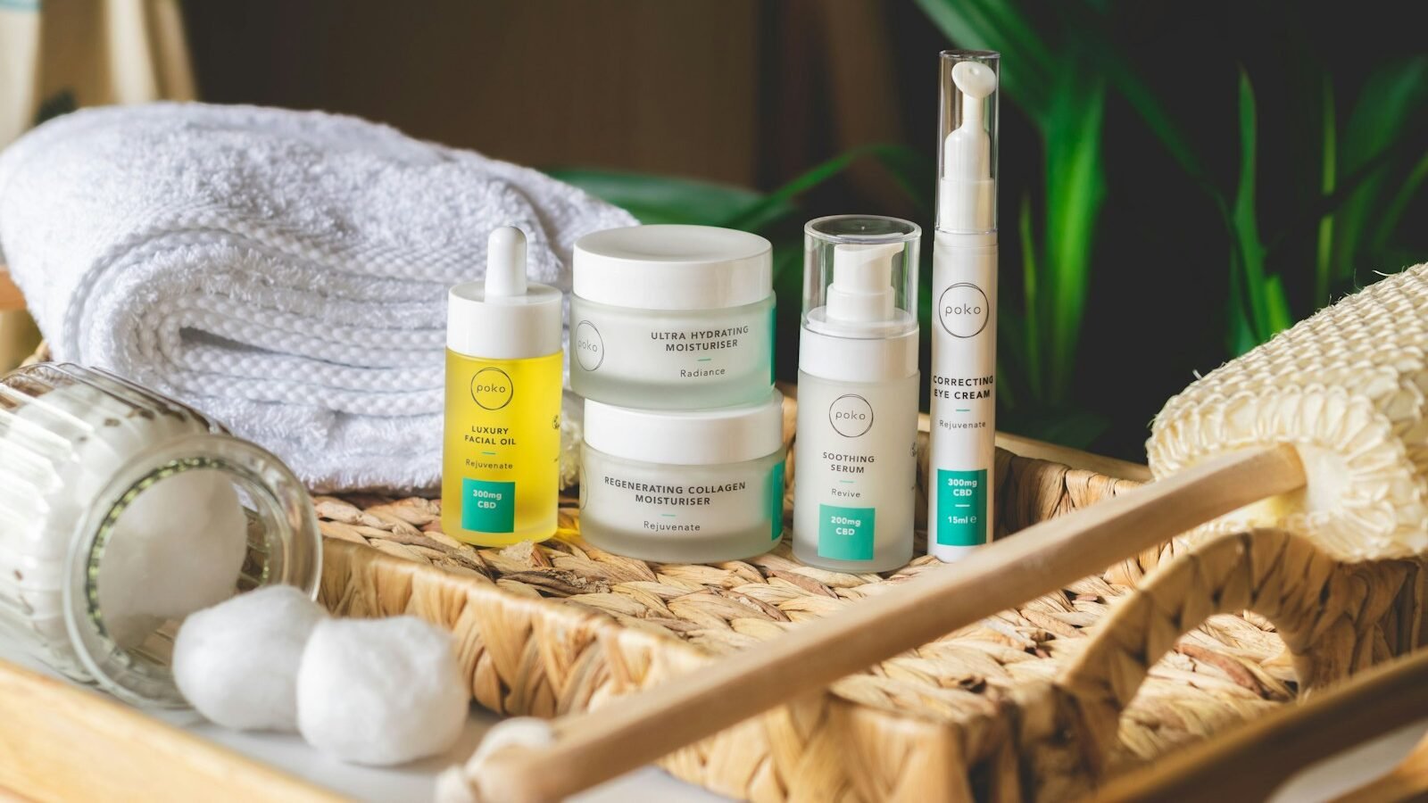 White and green plastic bottles of skin moisturizer on a brown woven basket.