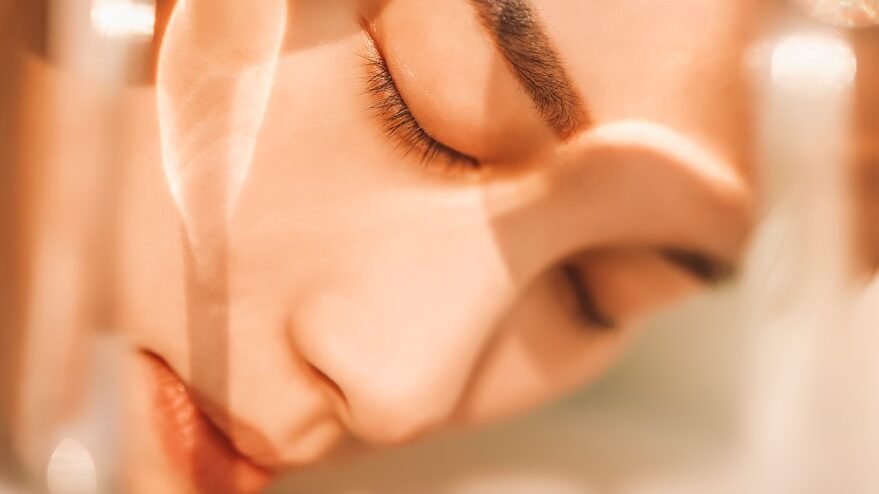 woman washing off a face gel mask
