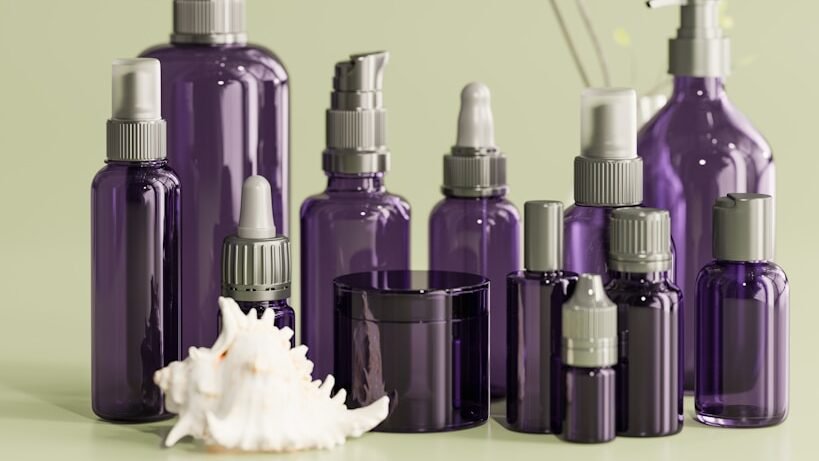 a group of purple bottles sitting on top of a table