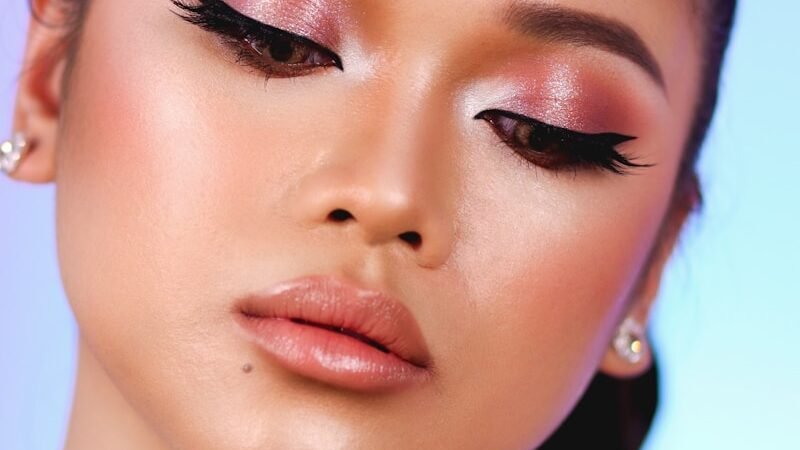 A woman's face with flawless makeup, showcasing a premium beauty product